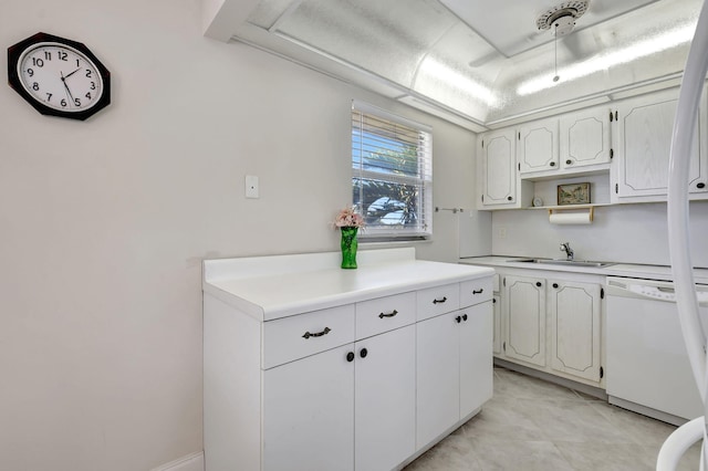 kitchen featuring dishwasher, sink, and white cabinets