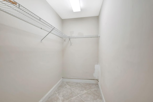 spacious closet featuring light tile patterned floors