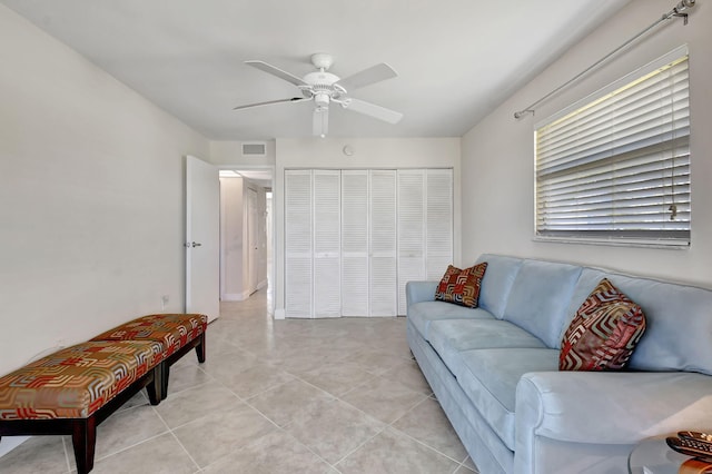 living room with ceiling fan and light tile patterned floors