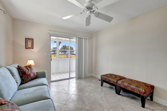 living room featuring light tile patterned floors and ceiling fan