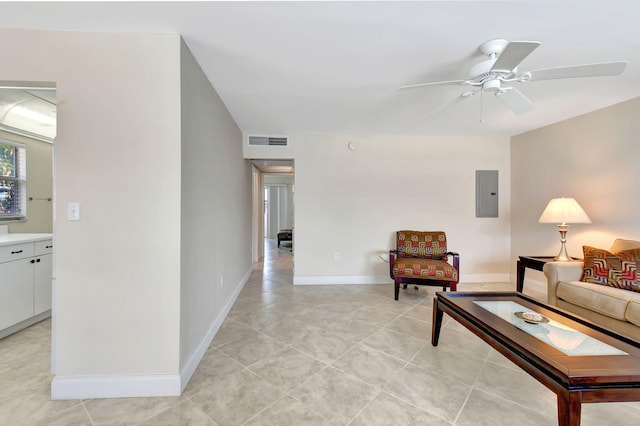 living room featuring electric panel, ceiling fan, and light tile patterned floors