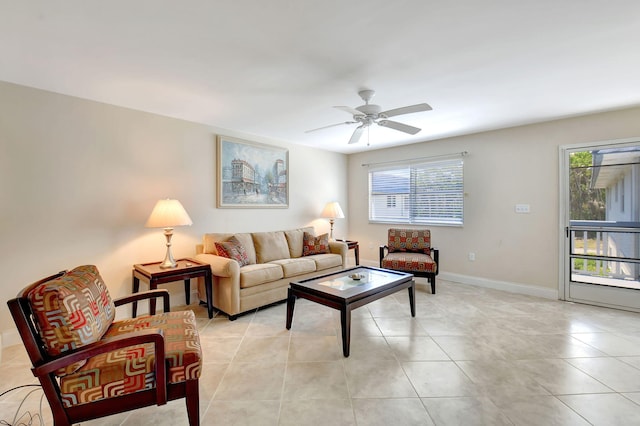 living room featuring a wealth of natural light, ceiling fan, and light tile patterned floors