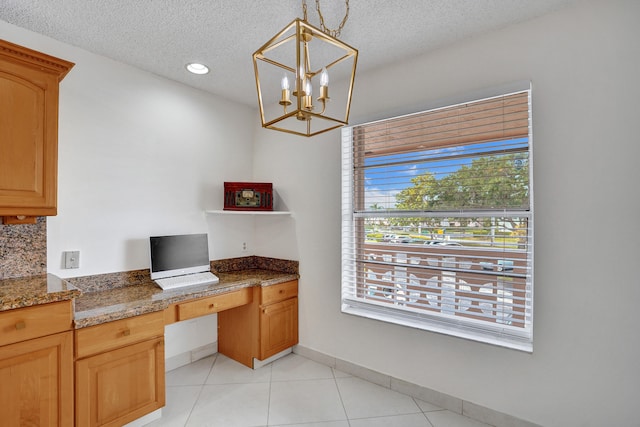 1260 NW 20th Ave Unit 203, Delray Beach, FL 33445 - unfurnished office with a chandelier, light tile patterned flooring, built in study area, baseboards, and a textured ceiling