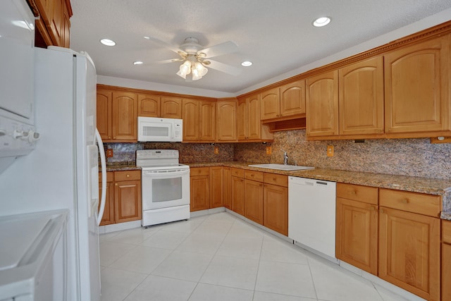 1260 NW 20th Ave Unit 203, Delray Beach, FL 33445 - kitchen featuring stone countertops, a sink, backsplash, and white appliances