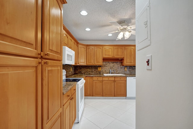 1260 NW 20th Ave Unit 203, Delray Beach, FL 33445 - kitchen featuring a textured ceiling, decorative backsplash, a sink, ceiling fan, and white appliances