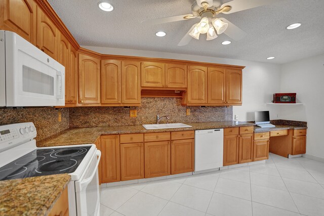1260 NW 20th Ave Unit 203, Delray Beach, FL 33445 - kitchen featuring a sink, ceiling fan, backsplash, white appliances, and a textured ceiling