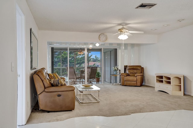1260 NW 20th Ave Unit 203, Delray Beach, FL 33445 - tiled living room with a ceiling fan, carpet flooring, a textured ceiling, and visible vents