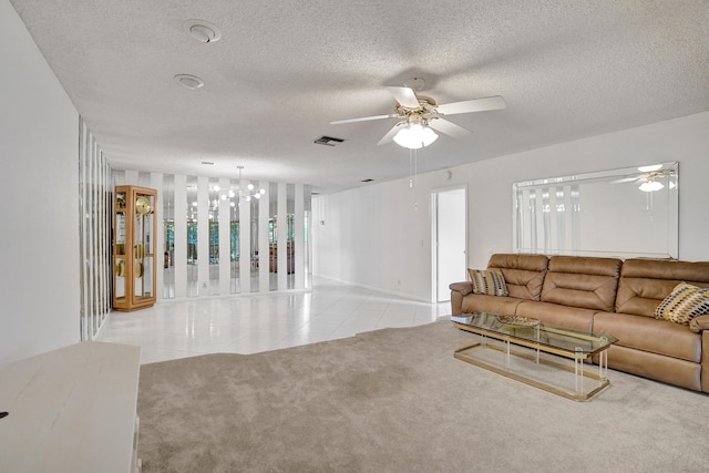 1260 NW 20th Ave Unit 203, Delray Beach, FL 33445 - living room featuring a textured ceiling, light tile patterned floors, visible vents, baseboards, and ceiling fan with notable chandelier