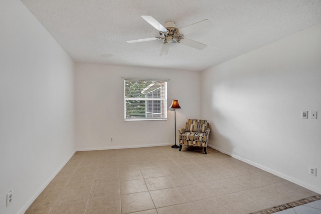1260 NW 20th Ave Unit 203, Delray Beach, FL 33445 - unfurnished room featuring tile patterned floors, a textured ceiling, a ceiling fan, and baseboards