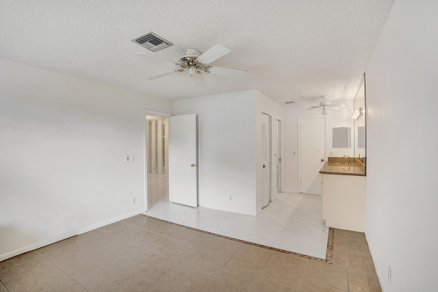 1260 NW 20th Ave Unit 203, Delray Beach, FL 33445 - unfurnished bedroom featuring light tile patterned floors, a textured ceiling, visible vents, and ceiling fan
