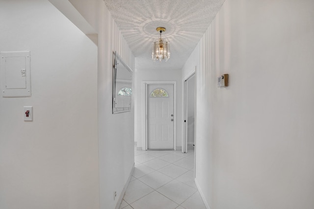 1260 NW 20th Ave Unit 203, Delray Beach, FL 33445 - corridor with baseboards, a notable chandelier, and light tile patterned flooring