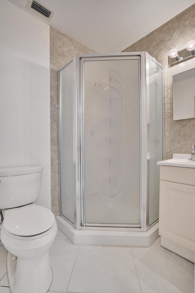 1260 NW 20th Ave Unit 203, Delray Beach, FL 33445 - bathroom with a shower stall, vanity, toilet, visible vents, and tile patterned flooring
