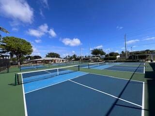 view of tennis court featuring basketball hoop