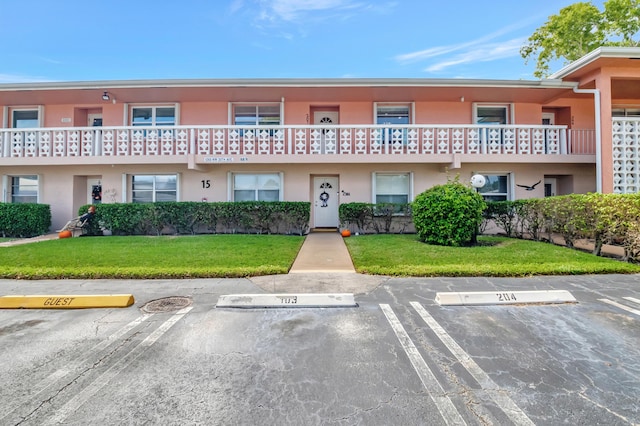 1260 NW 20th Ave Unit 203, Delray Beach, FL 33445 - view of property featuring uncovered parking