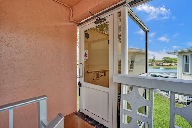 1260 NW 20th Ave Unit 203, Delray Beach, FL 33445 - property entrance featuring stucco siding and a water view