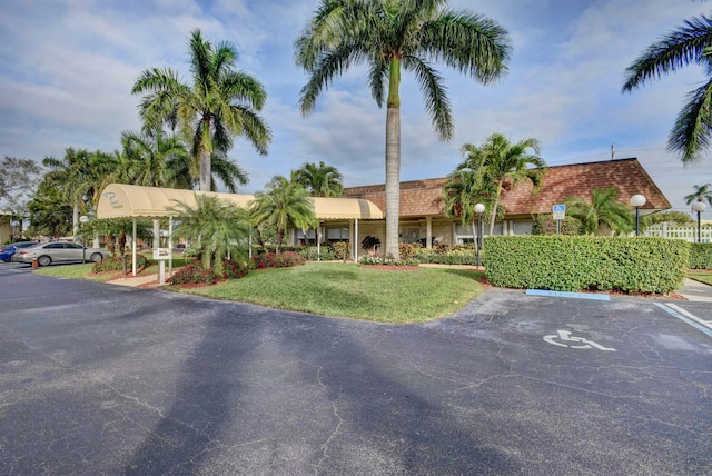 1260 NW 20th Ave Unit 203, Delray Beach, FL 33445 - view of front of property with uncovered parking and a front yard