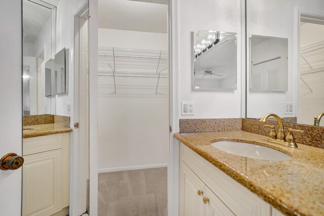 1260 NW 20th Ave Unit 203, Delray Beach, FL 33445 - bathroom with a walk in closet, ceiling fan, and vanity