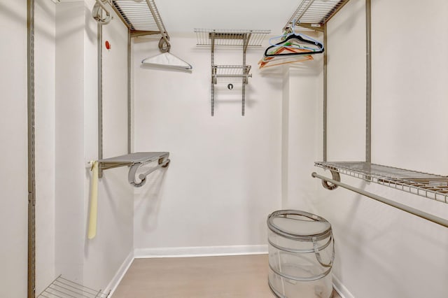 walk in closet with hardwood / wood-style floors