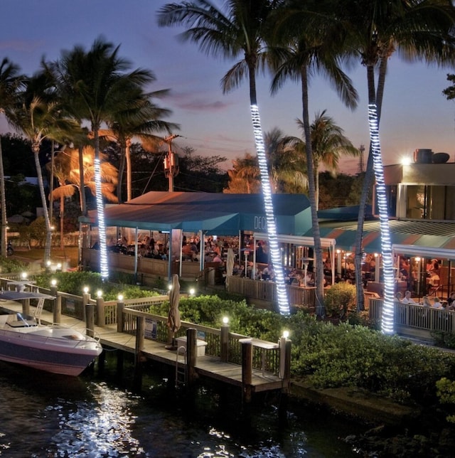 view of community with a dock and a water view