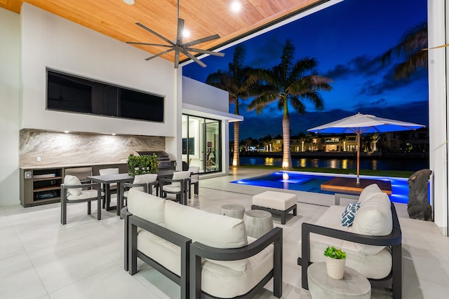 view of pool with a patio, outdoor lounge area, and ceiling fan