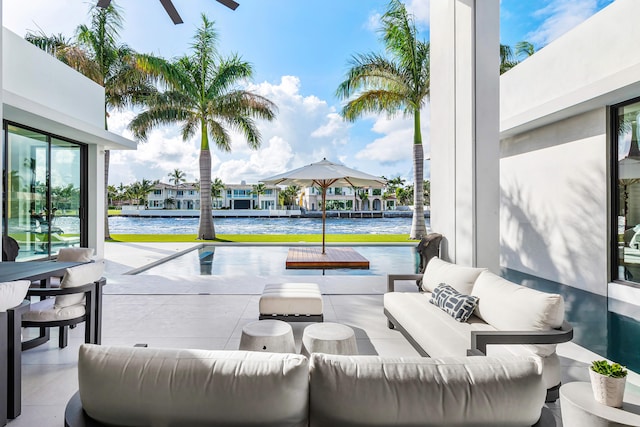 view of patio with outdoor lounge area and a water view