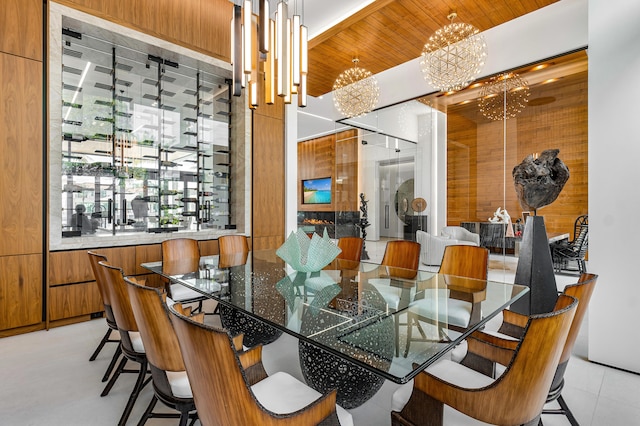 dining room featuring wood ceiling, wooden walls, and a notable chandelier