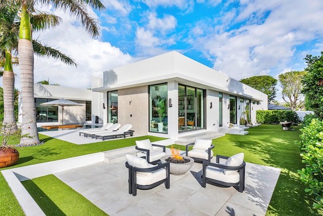 back of house featuring a patio and a yard