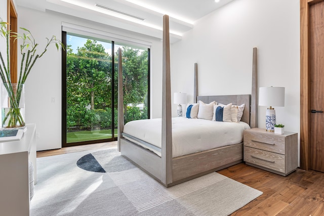 bedroom featuring access to exterior and light hardwood / wood-style flooring