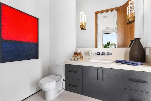 bathroom featuring toilet, vanity, and tile patterned floors