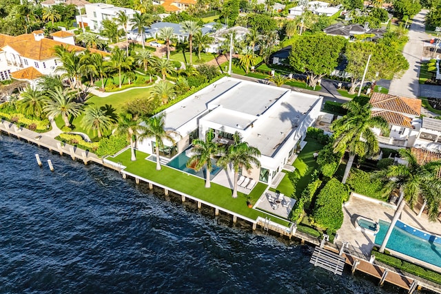 birds eye view of property with a water view