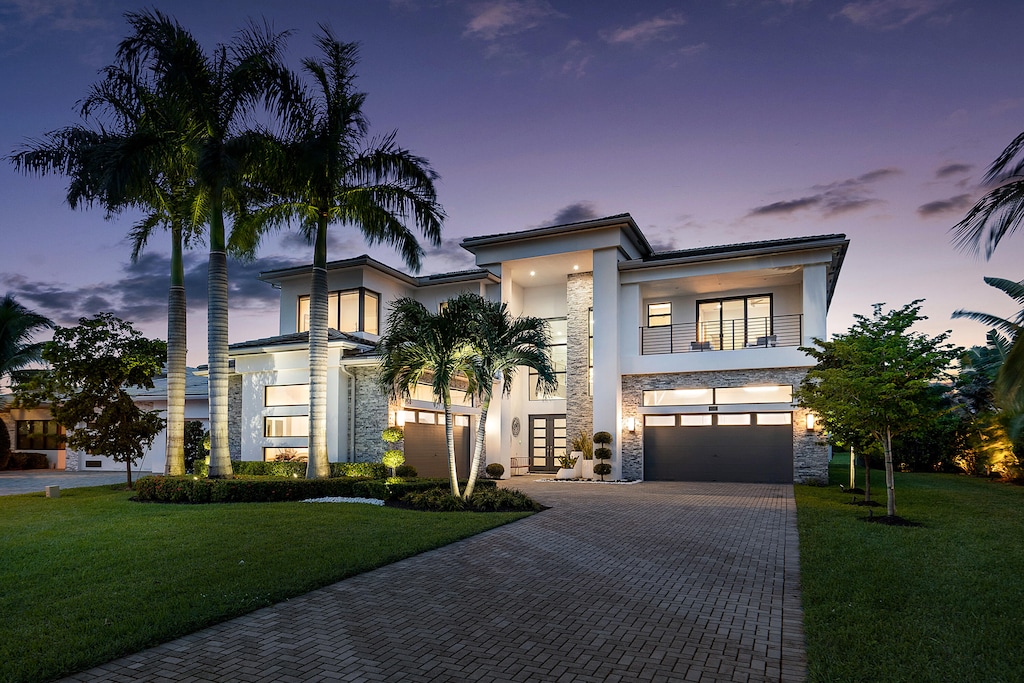 view of front of house with a garage and a yard