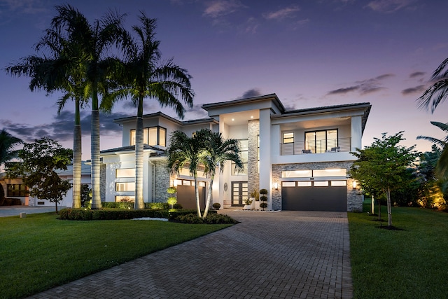 view of front of house with a garage and a yard