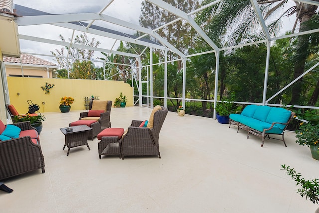 view of patio featuring outdoor lounge area and glass enclosure