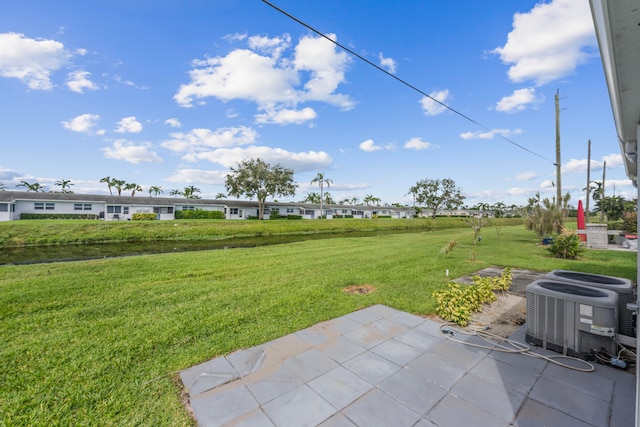 view of yard with central AC unit and a patio