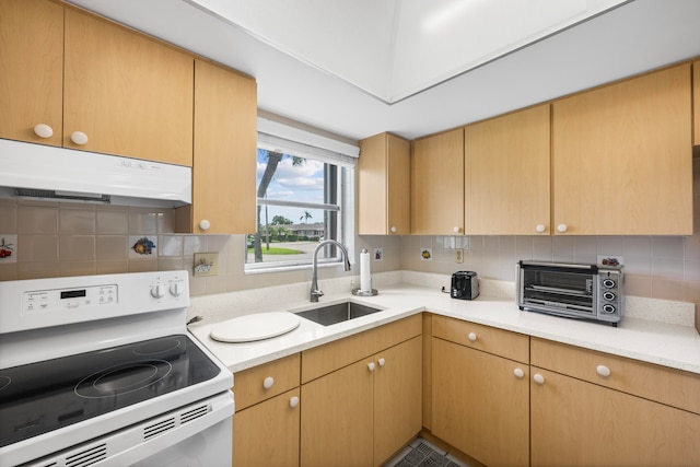 kitchen with backsplash, sink, and electric range