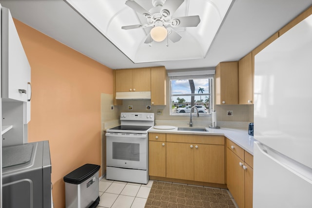 kitchen with light tile patterned floors, tasteful backsplash, white appliances, and sink