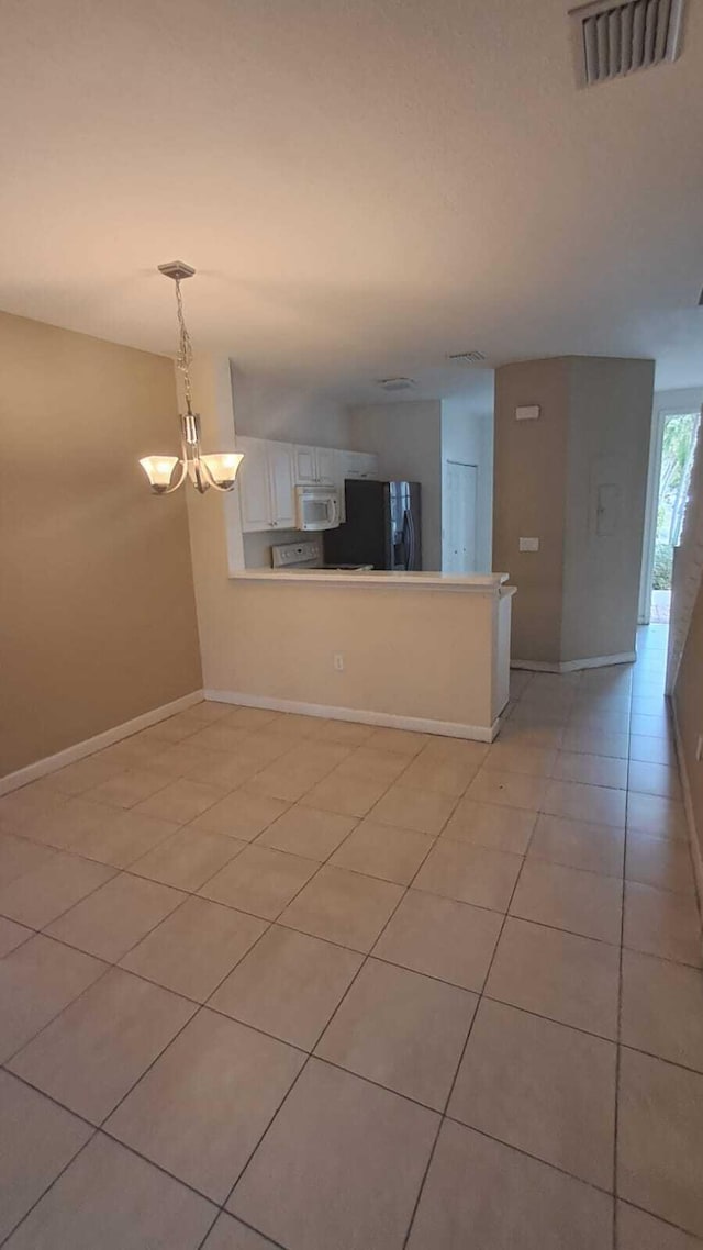 interior space featuring light tile patterned floors and a chandelier