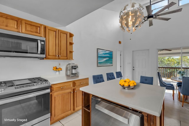 kitchen featuring light tile patterned floors, stainless steel appliances, light countertops, brown cabinets, and open shelves