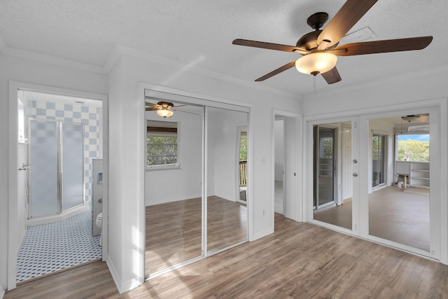 unfurnished sunroom with a ceiling fan and a wealth of natural light