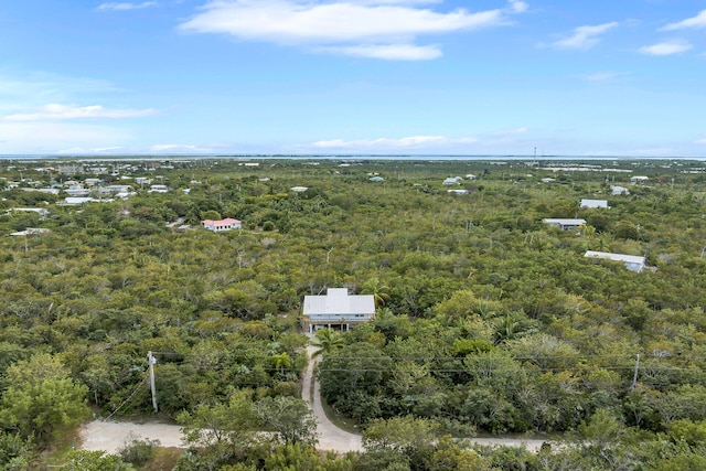 drone / aerial view featuring a wooded view