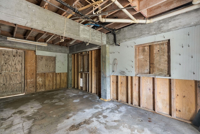 misc room with unfinished concrete floors