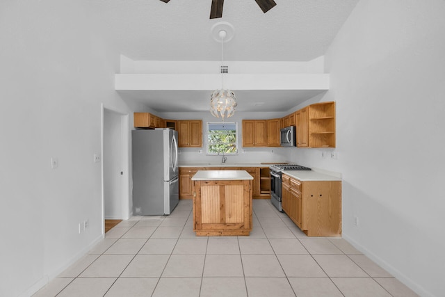 kitchen featuring a center island, hanging light fixtures, stainless steel appliances, light countertops, and open shelves