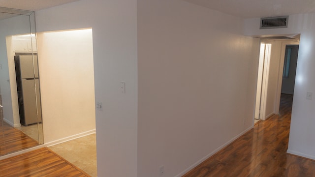 corridor featuring hardwood / wood-style floors