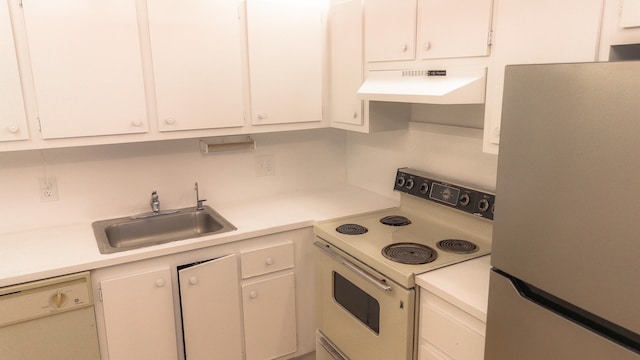 kitchen with white appliances, sink, and white cabinets