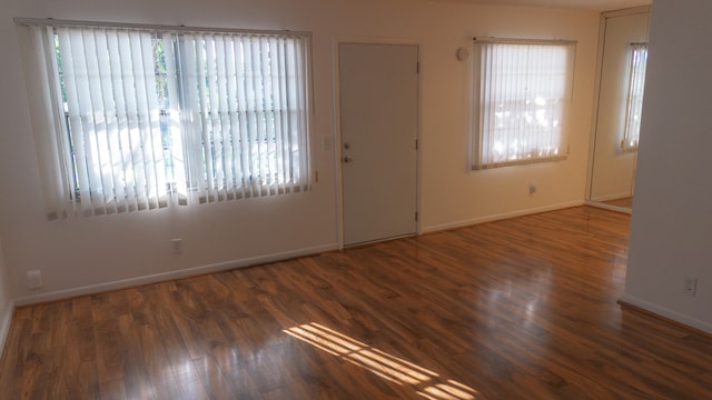 interior space with french doors, plenty of natural light, and dark hardwood / wood-style flooring