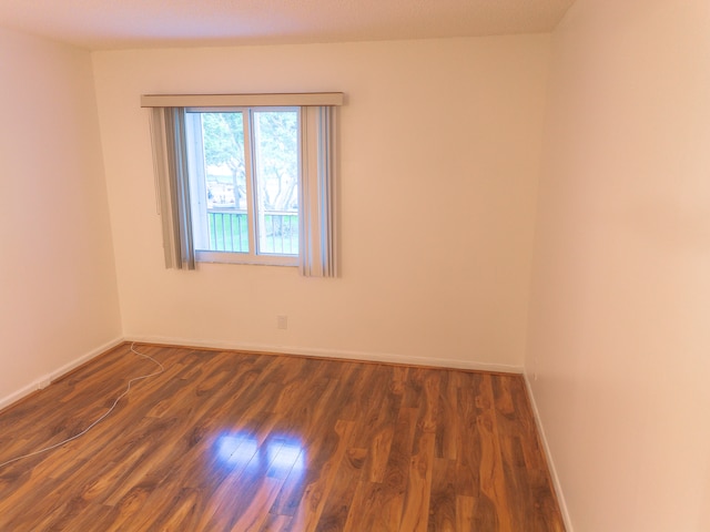 spare room featuring dark hardwood / wood-style floors