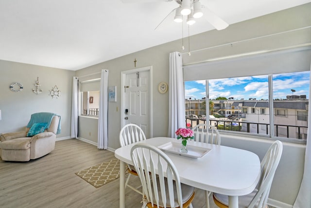 dining space featuring light wood-type flooring and ceiling fan