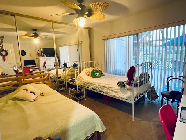 bedroom with a closet, ceiling fan, and dark carpet