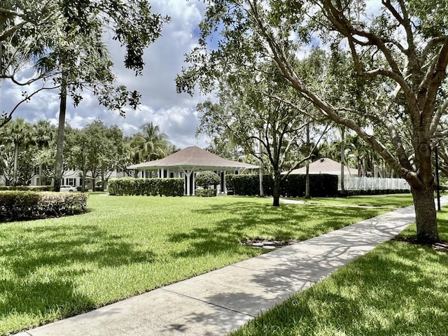 surrounding community with a yard, a gazebo, and fence