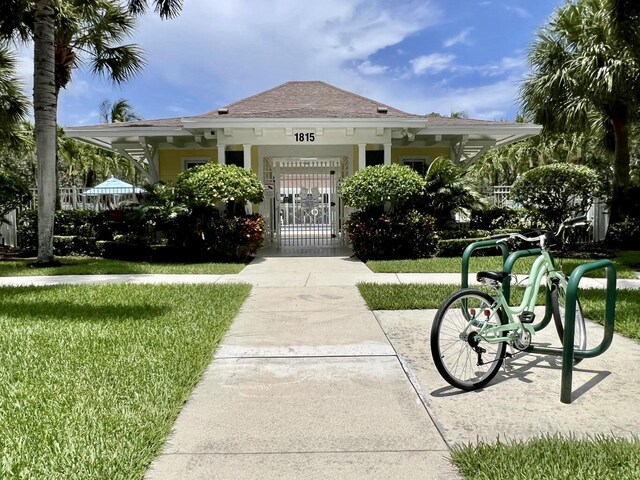 view of front of house with a gate and a front yard